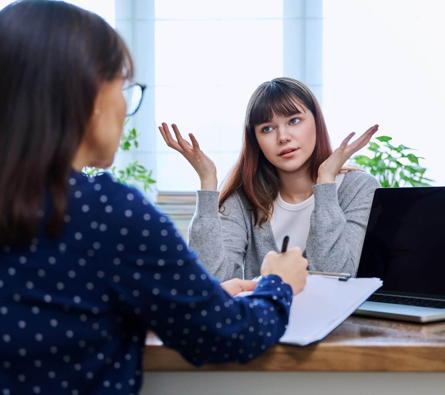 teenage-girl-at-therapy-session-with-mental-health-professional.jpg